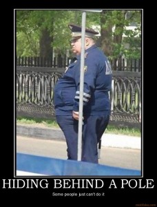Police officer behind pole